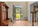 Inviting foyer with hardwood floors, coat rack, and view of the front yard at 17433 Glassfield Dr, Huntersville, NC 28078