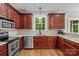 Cherry cabinet kitchen featuring stainless steel appliances, a window view and granite countertops at 17433 Glassfield Dr, Huntersville, NC 28078