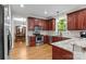 Well-lit kitchen featuring stainless steel appliances, granite countertops and cherry cabinets at 17433 Glassfield Dr, Huntersville, NC 28078
