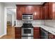 Well-equipped kitchen featuring stainless steel appliances, cherry cabinets and granite countertops at 17433 Glassfield Dr, Huntersville, NC 28078