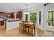 Sun-filled kitchen and dining area featuring granite countertops and stainless steel appliances at 17433 Glassfield Dr, Huntersville, NC 28078