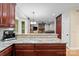 Open concept kitchen featuring granite countertops overlooking a living area with a fireplace at 17433 Glassfield Dr, Huntersville, NC 28078