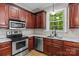 Charming kitchen featuring stainless steel appliances, wood floors, granite countertops and ample cabinet space at 17433 Glassfield Dr, Huntersville, NC 28078