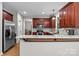 Spacious kitchen with stainless steel appliances, granite countertops and cherry cabinets with ample sunlight at 17433 Glassfield Dr, Huntersville, NC 28078