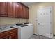 Laundry room with cabinets, sink, washer, and dryer at 17433 Glassfield Dr, Huntersville, NC 28078