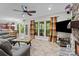 Spacious living room with stone fireplace, tile floors, and views of the backyard at 17433 Glassfield Dr, Huntersville, NC 28078