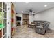 Cozy living room featuring a stone fireplace, tile floors, and comfortable gray sofa at 17433 Glassfield Dr, Huntersville, NC 28078