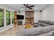 Bright living room with stone fireplace, tile floors, and comfortable gray sofa at 17433 Glassfield Dr, Huntersville, NC 28078