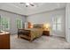 Main bedroom with tray ceilings, wood furniture, and natural light at 17433 Glassfield Dr, Huntersville, NC 28078