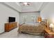 Main bedroom featuring tray ceilings, wood furniture, and a television at 17433 Glassfield Dr, Huntersville, NC 28078