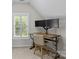 Office nook with a wood desk, comfortable chair, and natural light streaming through white shutters at 17433 Glassfield Dr, Huntersville, NC 28078