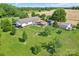 Aerial view highlighting the property's generous lot with a barn and other outbuildings at 1909 Mountain Springs Church Rd, Monroe, NC 28112