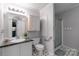 Bathroom featuring a toilet, shower, and sink at 1909 Mountain Springs Church Rd, Monroe, NC 28112