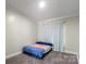 Neutral bedroom showcasing carpet and a comfortable bed with blue accents at 1909 Mountain Springs Church Rd, Monroe, NC 28112