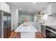 Bright kitchen with white cabinets, stainless steel appliances, and a large island with a quartz countertop at 1909 Mountain Springs Church Rd, Monroe, NC 28112