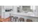 Modern kitchen features white quartz counters and bar seating, ideal for entertaining and casual dining at 1909 Mountain Springs Church Rd, Monroe, NC 28112