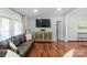 Cozy living room featuring hardwood floors, ample seating, and natural light at 1909 Mountain Springs Church Rd, Monroe, NC 28112