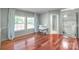 Bright living room featuring hardwood floors, multiple windows, and a modern desk space at 1909 Mountain Springs Church Rd, Monroe, NC 28112