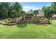 Backyard features a tiered stone waterfall feature and green lawn space at 1912 Dawnhurst Ln, York, SC 29745