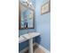 Stylish powder room featuring blue walls, framed starfish art, and a pedestal sink at 1912 Dawnhurst Ln, York, SC 29745