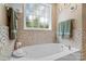 Relaxing bathroom featuring a large tub with mosaic tile surround and decorative accents at 1912 Dawnhurst Ln, York, SC 29745
