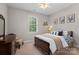 Comfortable bedroom with a dark wood bed frame, dresser, and soft carpet at 1912 Dawnhurst Ln, York, SC 29745