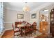 Traditional dining room featuring a wooden table set with china, framed art, and hardwood floors at 1912 Dawnhurst Ln, York, SC 29745