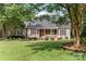 Charming single-story home with welcoming front porch, well-manicured lawn and mature trees at 1912 Dawnhurst Ln, York, SC 29745