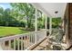Relaxing front porch with seating overlooking a lush, landscaped front yard and mature trees at 1912 Dawnhurst Ln, York, SC 29745