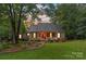 Charming single-story home featuring a well-manicured lawn, mature trees, and a welcoming front porch at 1912 Dawnhurst Ln, York, SC 29745