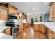 Bright kitchen with wooden cabinets, stainless steel appliances, and hardwood flooring at 1912 Dawnhurst Ln, York, SC 29745