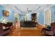 Open-concept living room featuring hardwood floors, a stone fireplace, and a bar area at 1912 Dawnhurst Ln, York, SC 29745