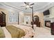 Spacious primary bedroom with a four-poster bed, fireplace, and sitting area at 1912 Dawnhurst Ln, York, SC 29745
