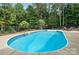 Sparkling in-ground pool surrounded by a black fence and lush greenery at 1912 Dawnhurst Ln, York, SC 29745
