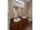 Bathroom with a double sink vanity, large mirror, and a toilet at 2012 Ashley Rd, Charlotte, NC 28208