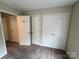 This bedroom features neutral carpet and walls, multiple doors and built-in closet space at 2012 Ashley Rd, Charlotte, NC 28208