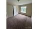 Bedroom with a window, closet, and neutral carpeting at 2012 Ashley Rd, Charlotte, NC 28208
