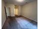 A spacious bedroom with neutral carpeting and natural light coming in from the window at 2012 Ashley Rd, Charlotte, NC 28208
