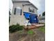 Damaged two-story home featuring a front porch, siding, and windows covered with a blue tarp at 2012 Ashley Rd, Charlotte, NC 28208