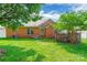 Spacious backyard showcasing lush green lawn, mature trees, and a brick exterior, perfect for outdoor activities at 2079 Audubon Dr, Rock Hill, SC 29732