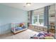 Charming bedroom with built-in shelves, storage, and a light blue wall at 2079 Audubon Dr, Rock Hill, SC 29732
