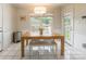 Bright dining area with wooden table, white bench, and natural light from large windows at 2079 Audubon Dr, Rock Hill, SC 29732