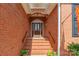 The brick house features an elegant front door with glass accents and classic design, framed by brick steps at 2079 Audubon Dr, Rock Hill, SC 29732