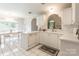 Bright kitchen featuring white cabinets, tile flooring, and dining area with natural light at 2079 Audubon Dr, Rock Hill, SC 29732