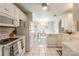 Bright white kitchen with tile flooring, modern appliances, and open layout to dining area at 2079 Audubon Dr, Rock Hill, SC 29732