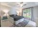 Cozy bedroom with tray ceiling, ceiling fan, and large window providing natural light at 2079 Audubon Dr, Rock Hill, SC 29732