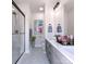 Bright bathroom features double vanity, sleek fixtures, glass enclosed shower, and tasteful decor at 2158 N Graham St # 14, Charlotte, NC 28206
