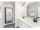 Elegant bathroom with a double vanity, framed mirrors, walk-in shower, and modern fixtures at 223 S Bruns Ave, Charlotte, NC 28208