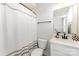 Bright bathroom with a shower-tub combination, a white vanity, and modern black hardware at 223 S Bruns Ave, Charlotte, NC 28208