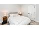Simple bedroom featuring a soft bed, side tables, and a neutral color palette at 223 S Bruns Ave, Charlotte, NC 28208